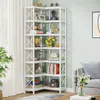 A white corner bookshelf filled with decorative items and books, placed in a room with light green walls and a window with white curtains. Náhled obrázku produktu