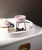 A pink wax burner with a lit candle underneath sits on a white tray, next to a package of Yankee Candle wax melts. Produktbild-Vorschau
