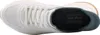 A top-down view of a white Skechers slip-on shoe. Voir les images du produit