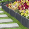 A garden path with stepping stones leading past a flower bed bordered by a dark gray plastic fence. Náhľad obrázku produktu