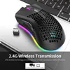 A black wireless gaming mouse with RGB lighting is placed on a laptop keyboard. Produktbild-Vorschau
