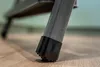 Close-up of the rubber foot of a gray metal ladder leg on a wooden floor. Anteprima dell’immagine prodotto
