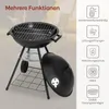 A black charcoal grill with its lid off, displayed outdoors with a blurred background of tents and chairs. Icons and text describing features are on the right side. Produktbild-Vorschau
