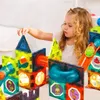 A young girl is playing with magnetic building blocks, constructing a marble run. Náhľad obrázku produktu