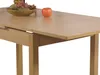 A close-up of a wooden dining table with fruit in a bowl and an apple on top. Produktbild-Vorschau