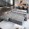 A modern living room with a large sectional sofa, dining table and chairs, and a staircase. Produktbild-Vorschau