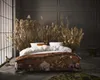 A bedroom scene with a bed adorned with dried flowers and foliage, creating a natural and bohemian ambiance. Produktbild-Vorschau