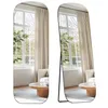 Two views of a full-length mirror reflecting a room with a window, curtains, and furniture. Produktbild-Vorschau