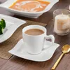 A table setting with a cup of coffee, a plate of broccoli, and a bowl of soup. Produktbild-Vorschau
