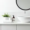 A clean and minimalist bathroom countertop with various accessories. Anteprima dell’immagine prodotto