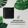 A black mini-fridge is shown surrounded by large green leaves, with text indicating it is economical and environmentally friendly. Produktbild-Vorschau