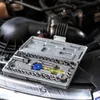 A tool kit is placed on top of a car engine. Produktbild-Vorschau