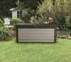 A storage box is placed on a green lawn in a garden setting, with a white chair and a small shed in the background. Produktbild-Vorschau