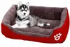 A husky puppy lies in a red and gray dog bed. Anteprima dell’immagine prodotto