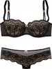 A black and caramel lace bra and panty set is displayed against a white background. Produktbild-Vorschau