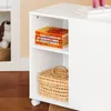 A white storage unit with shelves, containing books and a basket. It has wheels at the bottom. Náhľad obrázku produktu