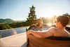 A couple relaxing in a hot tub with a scenic view. Náhled obrázku produktu