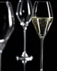 Three champagne flutes are shown against a black background. One flute in the foreground is filled with champagne, while the other two are empty and slightly out of focus. Anteprima dell’immagine prodotto