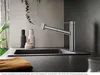 A modern kitchen sink area with a faucet, soap dispenser, and a plant. Produktbild-Vorschau