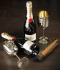 Two bottles of Moët & Chandon champagne and two gold-colored glasses are arranged on a dark wooden surface. Podgląd zdjęcia produktu