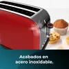 A close-up of a red toaster with stainless steel accents, next to some baked goods. Voir les images du produit
