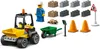 A collection of LEGO construction toys, including a front loader vehicle, a construction worker minifigure, building blocks, traffic cones, a wheelbarrow, and a road sign. Produktbild-Vorschau