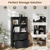A black bookshelf with multiple compartments and drawers, shown in a room setting with decorative items and plants. Podgląd zdjęcia produktu