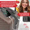 A woman is smiling and holding a smartphone, with a suitcase in the foreground. The suitcase has a phone plugged into it, showing a charging icon. Produktbild-Vorschau