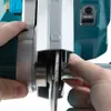 A close-up shot of hands adjusting a cutting disc on a power tool. Voir les images du produit