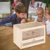 Children looking at a hamster cage on a wooden table. Náhľad obrázku produktu