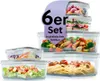 A collection of glass food storage containers filled with various foods, presented in a stacked arrangement. Voir les images du produit