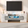 A modern TV stand with a large black television mounted above it. Podgląd zdjęcia produktu