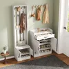 A hallway or entryway with a white coat rack and shoe cabinet set against a light green wall. Produktbild-Vorschau