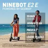 Two people riding electric scooters on a beach. Voir les images du produit