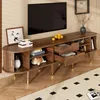 A TV stand with a television and various decorative items in a living room setting. Anteprima dell’immagine prodotto