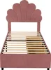 A pink upholstered bed frame with a shell-shaped headboard and wooden slats for a mattress. Produktbild-Vorschau