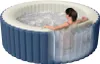 A woman relaxing in an inflatable hot tub. Produktbild-Vorschau
