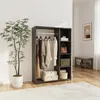 A wardrobe with clothes hanging on a rail and shelves with storage boxes and a handbag. Náhled obrázku produktu