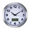 A white wall clock with a silver frame, featuring a digital display for weather information. Anteprima dell’immagine prodotto