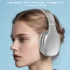 A woman wearing silver over-ear headphones against a light blue background. Náhľad obrázku produktu
