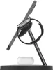 A charging stand for a smartphone and smartwatch, with wireless earbuds resting on the base. Produktbild-Vorschau