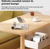 A close-up of a wooden table with a magazine, remote control, and a cup of coffee. There is also a storage basket with books underneath the table. Produktbild-Vorschau