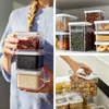 A collage of images showing clear plastic food storage containers filled with various dry goods like nuts, grains, and herbs, with a person holding a stack of containers in one panel. Produktbild-Vorschau