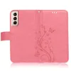 A pink phone case with a floral embossed pattern is shown open, displaying the inside. Produktbild-Vorschau