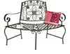 A green metal garden bench with a decorative floral backrest and a patterned cushion on the seat. Anteprima dell’immagine prodotto