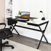 A black desk with a laptop, a cup, a plant, and a lamp. Náhled obrázku produktu