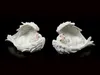 Two white angel figurines sleeping on a black background. Produktbild-Vorschau