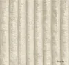 A close-up of a textured, beige fabric with vertical ribbed detailing. Podgląd zdjęcia produktu