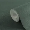 A roll of dark green textured wallpaper is shown in a close-up shot. Produktbild-Vorschau