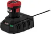 A black and red battery charger with a battery inserted, connected to a power cord. Podgląd zdjęcia produktu